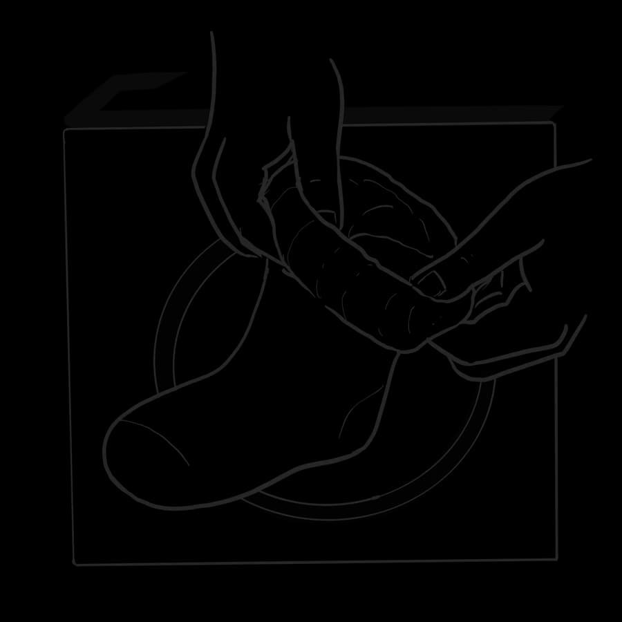 A sock mid-inversion, the cuff turned back over itself, the interior loops visible.