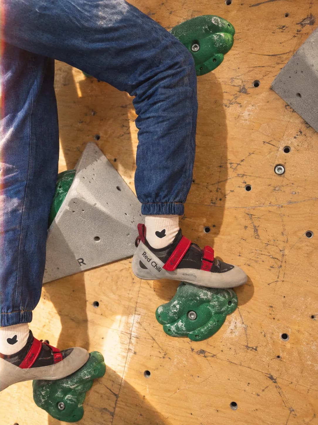 White socks worn with climbing shoes on a bouldering wall