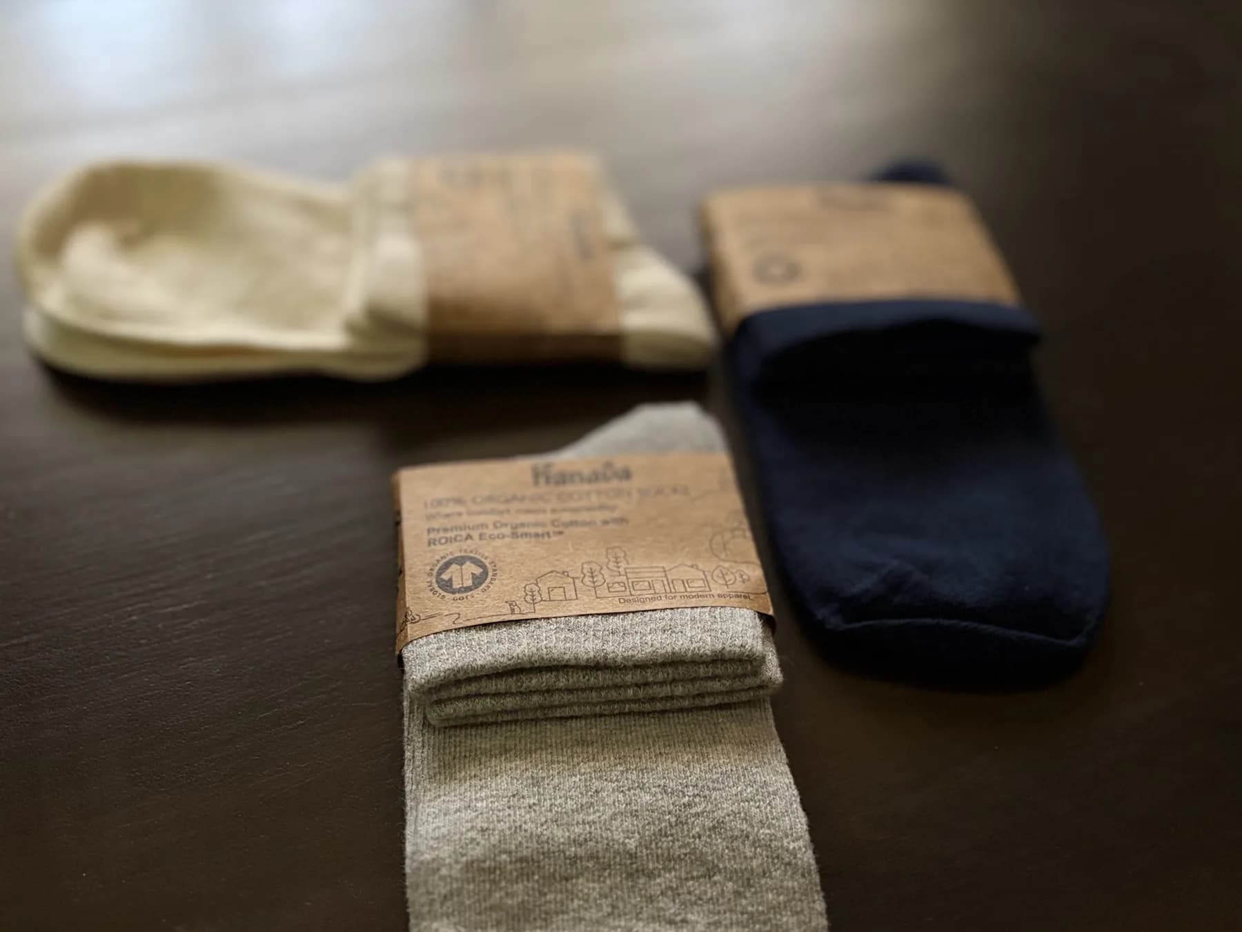 Basalt in oat, navy and grey, folded in their card wraps