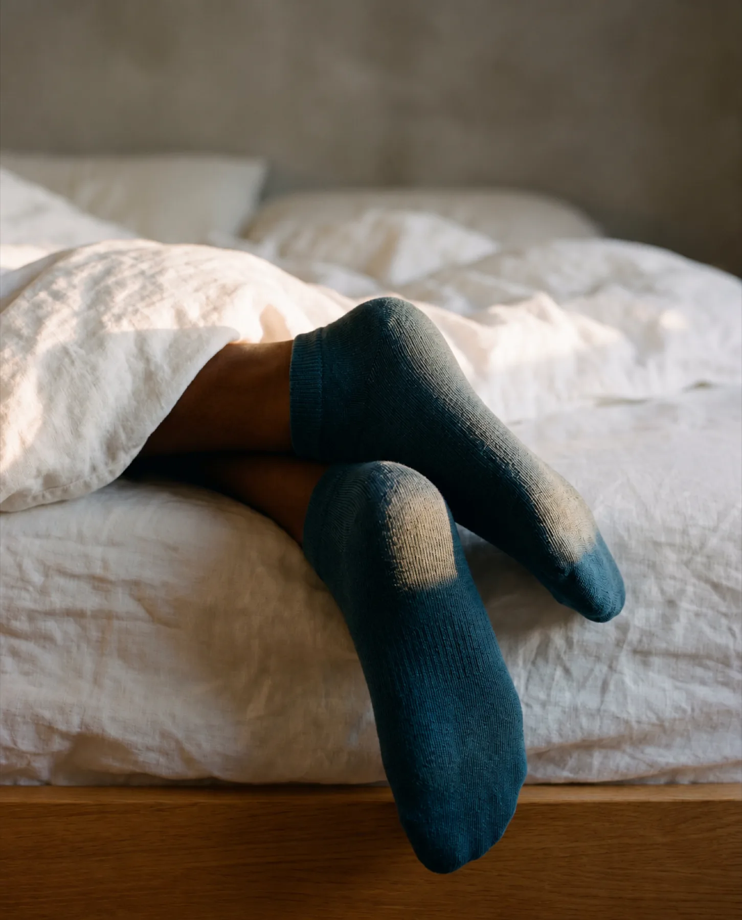 Vesper ankle socks, feet hanging off the end of the bed
